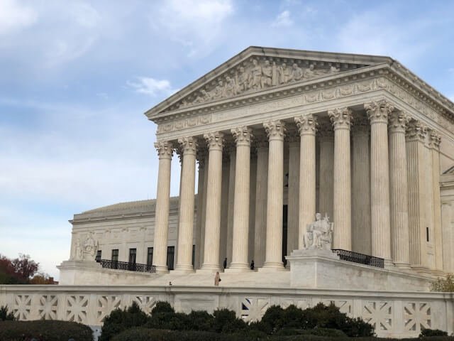 Federal courthouse exterior at dusk with stone steps and tall columns