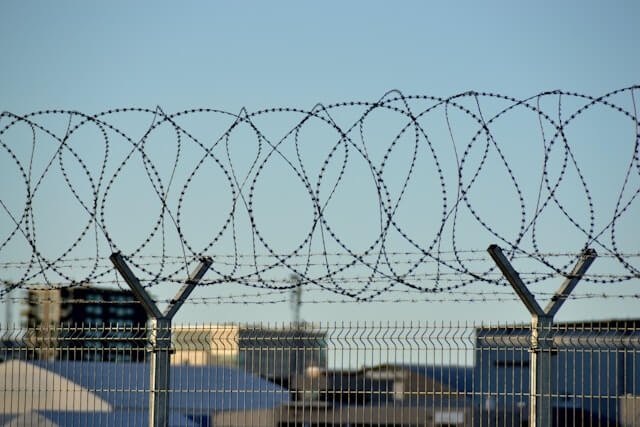 Chain-link perimeter fence at an immigration detention facility