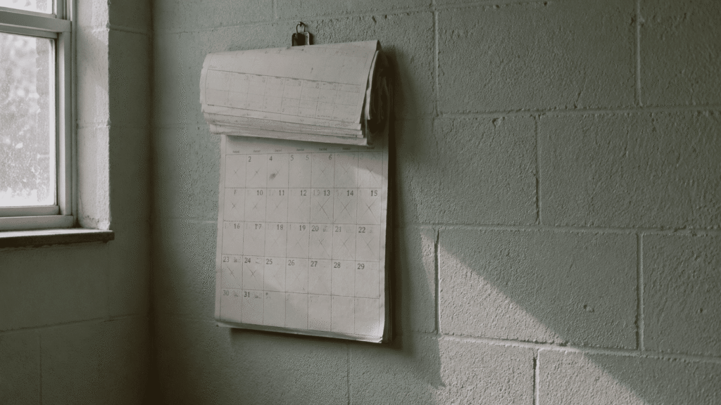 Wall calendar with months crossed off, representing prolonged ICE detention without a bond hearing